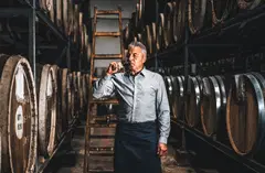 winemaker tasting wine in cellar