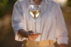 holding glass white wine