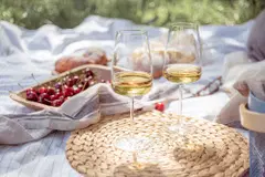 2 glass of wine with cherry in background