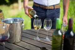 pours wine into a glass 2